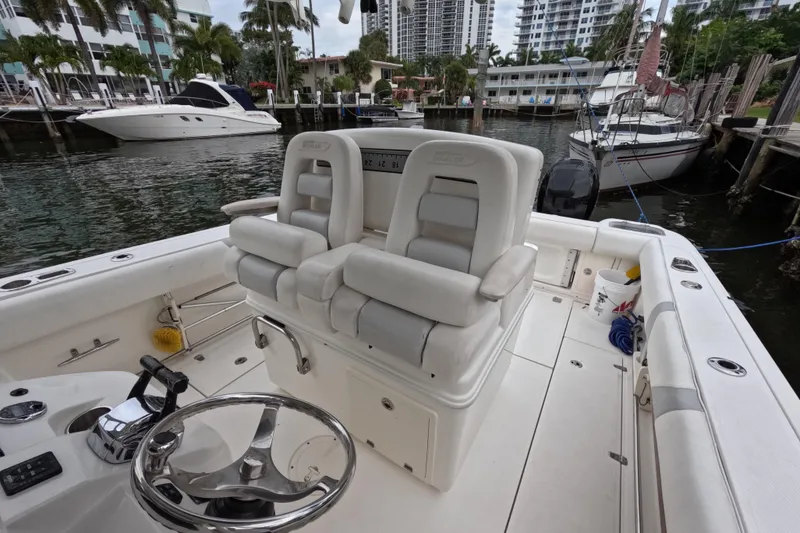 Slide: The Image of Open storage compartments on a 2013 Boston Whaler 320 Outrage boat. - 54