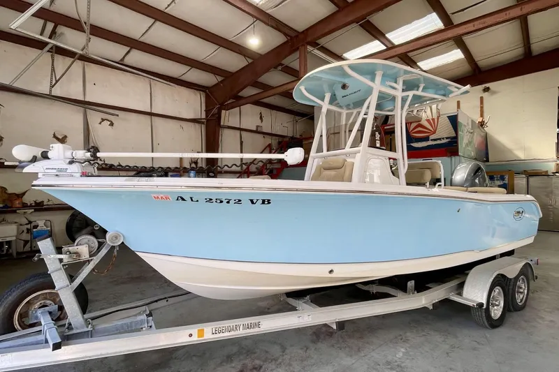 The Image of 2018 Sea Hunt Ultra 211 boat in a garage on a trailer. - 0