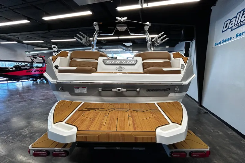 Slide: The Image of 2025 Supra SA boat with teak deck, showcased in a modern showroom. - 3