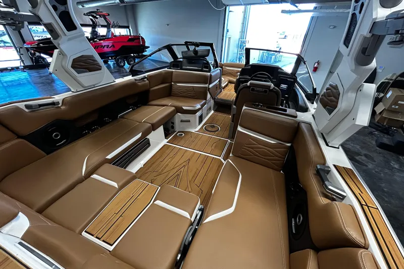 Slide: The Image of Luxurious interior of 2025 Supra SA boat with brown leather seating and modern design. - 5
