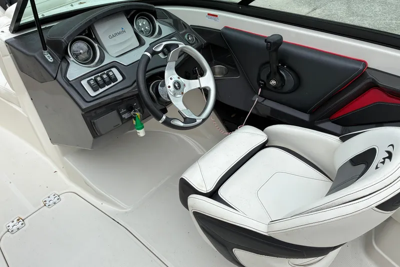 Slide: The Image of 2013 Monterey 214SS Super Sport boat interior with steering wheel and Garmin navigation system. - 11