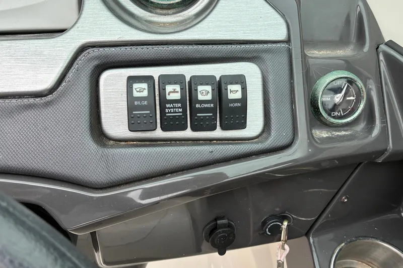 Slide: The Image of Dashboard controls of a 2013 Monterey 214SS Super Sport boat, featuring bilge, water system, blower, and horn switches. - 13