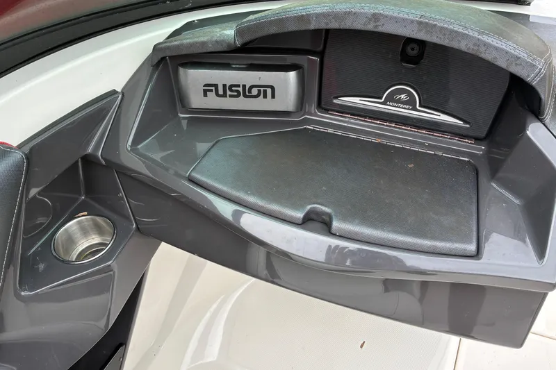 Slide: The Image of 2013 Monterey 214SS Super Sport boat dashboard with Fusion audio system and cup holder. - 14