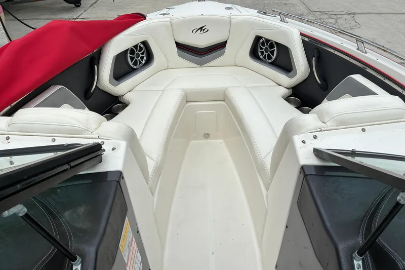 Slide: The Image of 2013 Monterey 214SS Super Sport boat interior with white seating and red cover. - 16