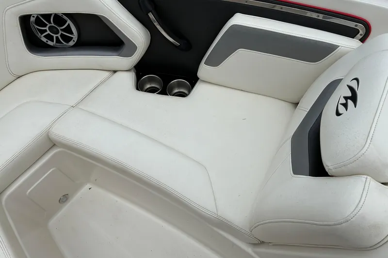 Slide: The Image of 2013 Monterey 214SS Super Sport boat interior with white seating and cup holders. - 17
