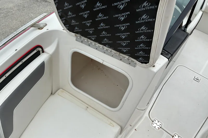 Slide: The Image of 2013 Monterey 214SS Super Sport boat storage compartment with open hatch and branded interior. - 19