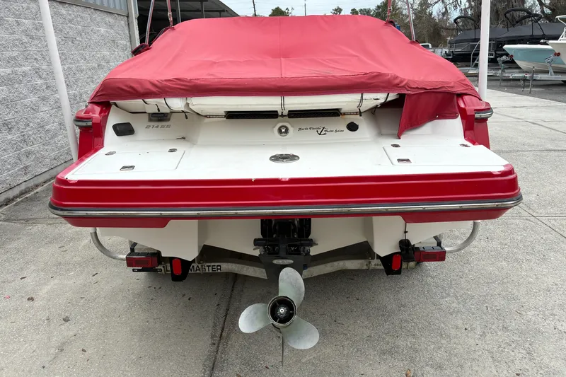 Slide: The Image of Rear view of a 2013 Monterey 214SS Super Sport boat with red cover. - 25