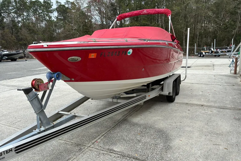 Slide: The Image of Red 2013 Monterey 214SS Super Sport boat on trailer, parked outdoors. - 28