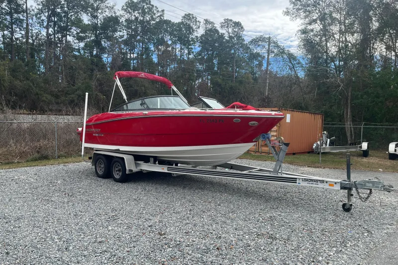 Slide: The Image of Red 2013 Monterey 214SS Super Sport boat on trailer, parked outdoors. - 30