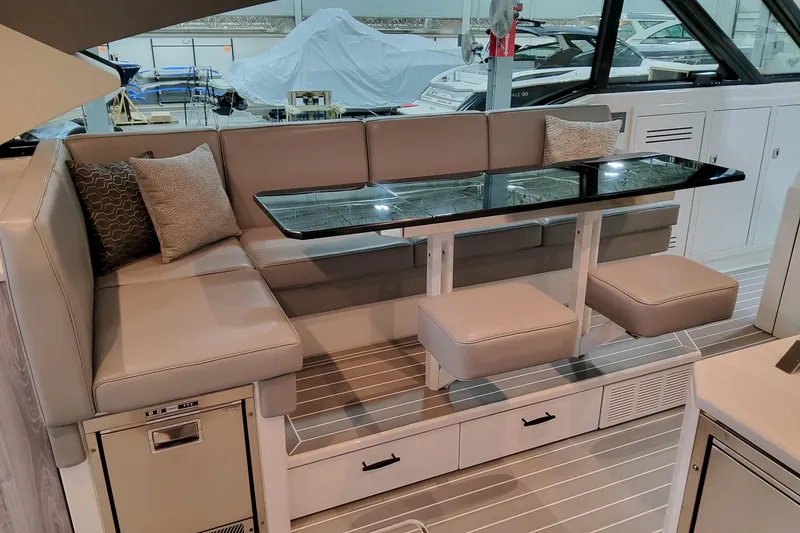 Slide: The Image of Luxurious seating area in 2026 Formula 500 Super Sport Crossover yacht, featuring elegant cushions and sleek design. - 13