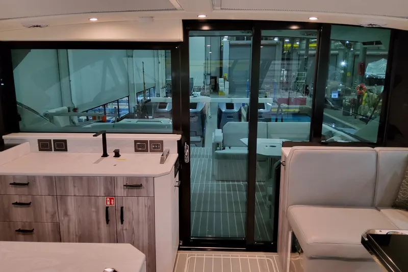 Slide: The Image of Interior of 2026 Formula 500 Super Sport Crossover yacht, featuring modern kitchen and seating area. - 16