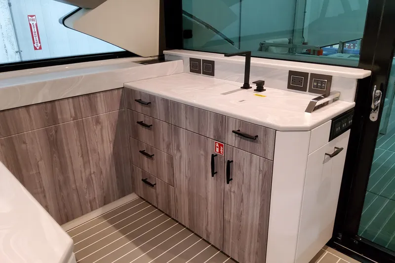 Slide: The Image of Modern kitchen area in 2026 Formula 500 Super Sport Crossover yacht, featuring sleek cabinetry and fixtures. - 17