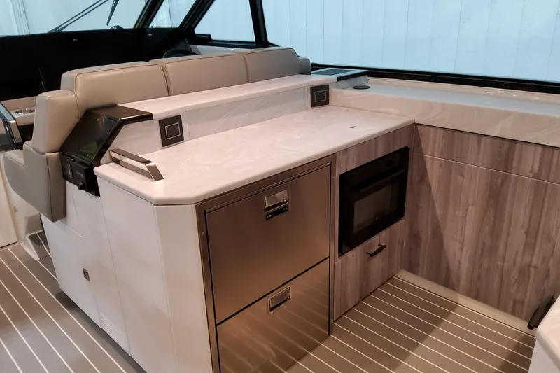 Slide: The Image of 2026 Formula 500 Super Sport Crossover interior with modern kitchenette and seating area. - 19