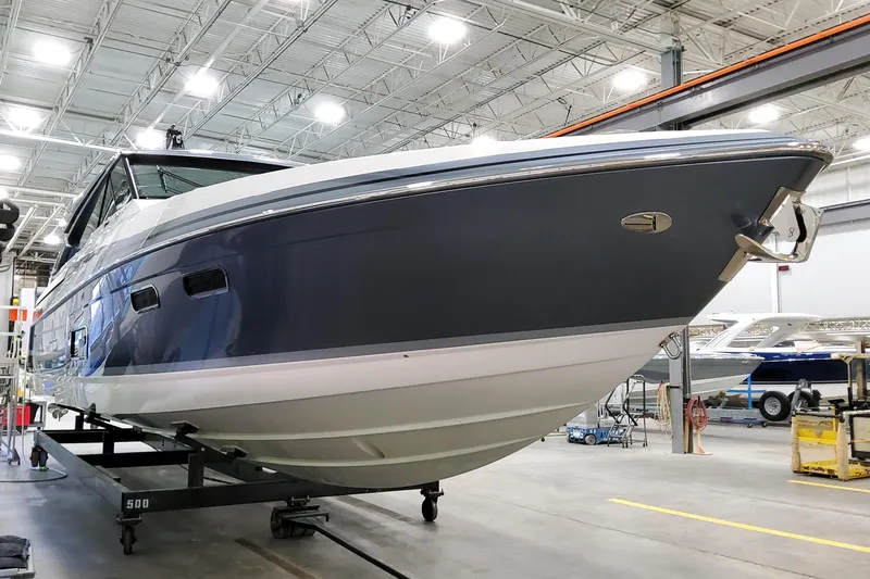 Slide: The Image of 2026 Formula 500 Super Sport Crossover boat in a showroom, showcasing sleek design. - 2