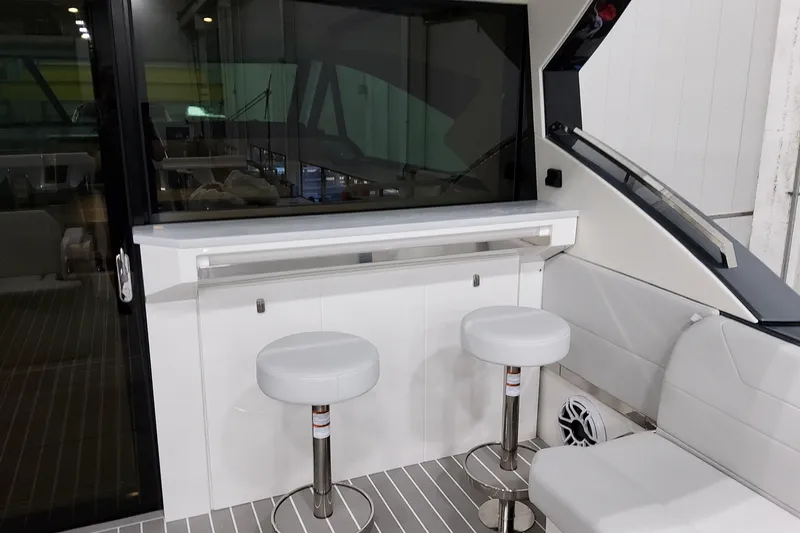 Slide: The Image of 2026 Formula 500 Super Sport Crossover interior with bar stools and sleek design. - 23