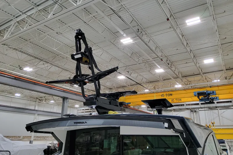 Slide: The Image of 2026 Formula 500 Super Sport Crossover in a factory setting with overhead cranes. - 37