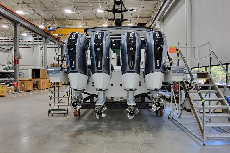 Slide: The Image of 2026 Formula 500 Super Sport Crossover with four powerful outboard engines in a spacious workshop. - 4