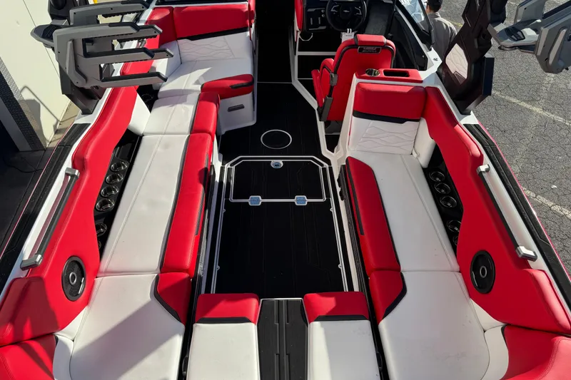 Slide: The Image of 2026 Supra SE 575 boat interior with red and white seating, black flooring, and modern design. - 11