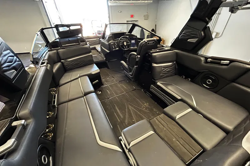 Slide: The Image of 2025 Supra SA boat interior with luxurious black seating and modern dashboard design. - 6