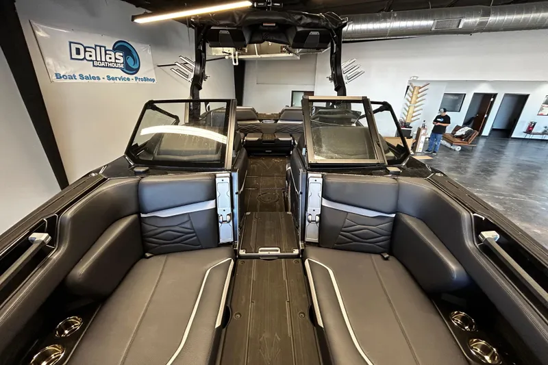 Slide: The Image of Interior of 2025 Supra SA boat at Dallas Boathouse showroom, featuring sleek seating and modern design. - 9