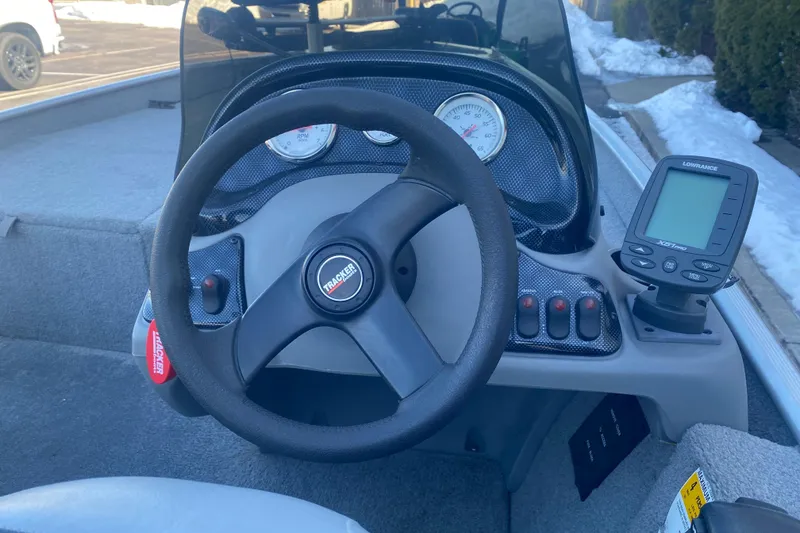 Slide: The Image of 2010 Tracker Pro Team 170 TX boat dashboard with steering wheel and fish finder. - 12