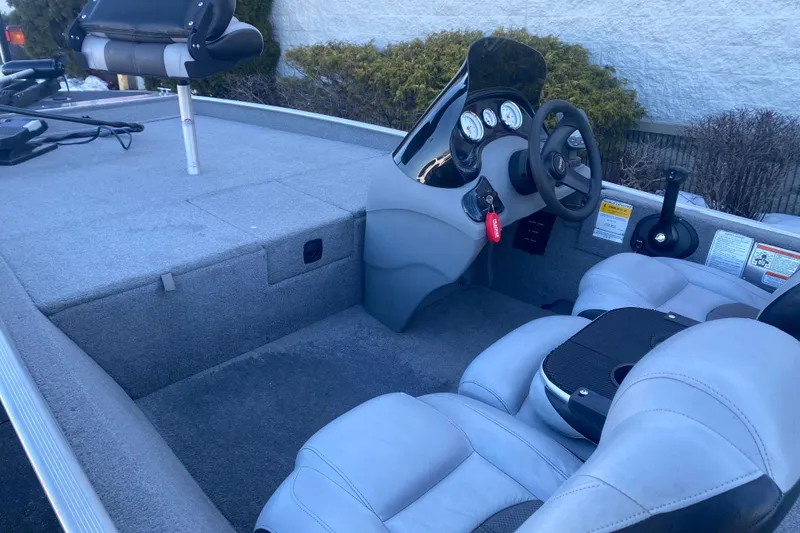 Slide: The Image of 2010 Tracker Pro Team 170 TX boat interior with steering console and seating. - 3