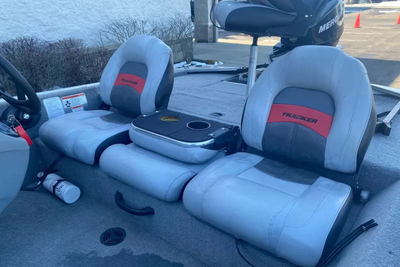 Slide: The Image of 2010 Tracker Pro Team 170 TX boat interior with gray seats and steering wheel. - 4