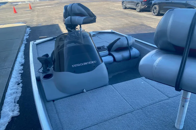Slide: The Image of 2010 Tracker Pro Team 170 TX boat interior with seating and console in a parking lot. - 5