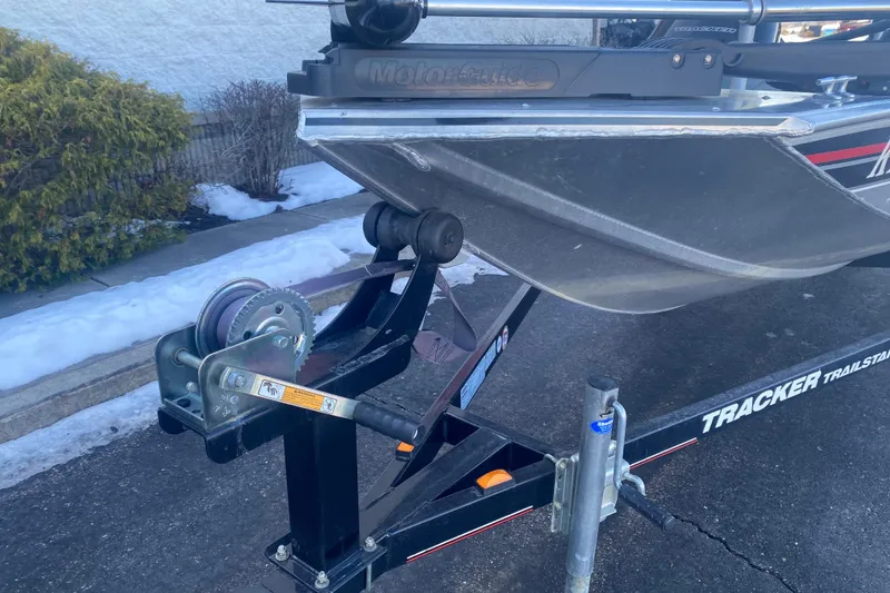 Slide: The Image of 2010 Tracker Pro Team 170 TX boat on trailer with winch, parked on snowy pavement. - 7