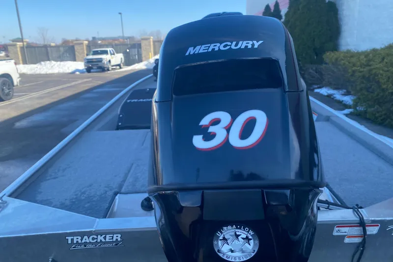 Slide: The Image of 2010 Tracker Pro Team 170 TX with Mercury 30 outboard motor in parking lot. - 8