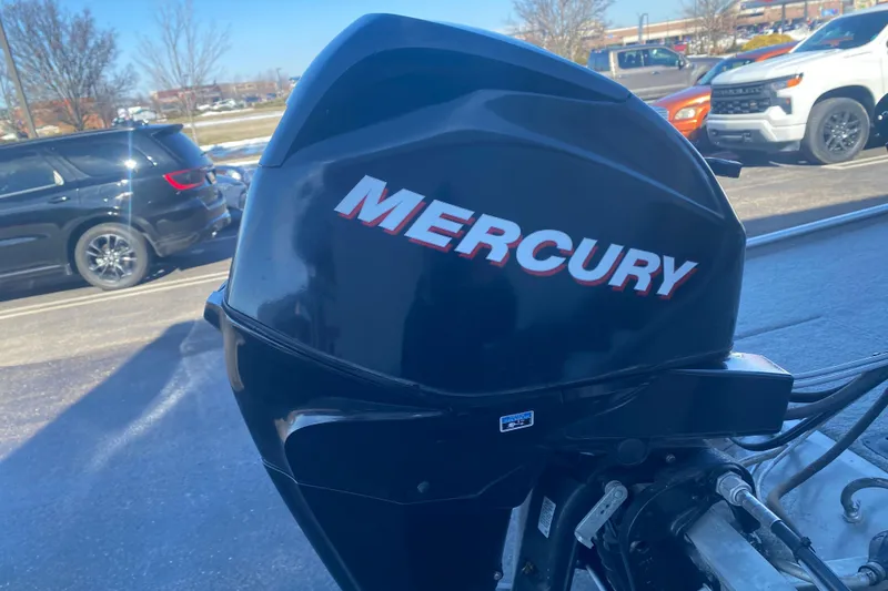 Slide: The Image of Mercury outboard motor on 2010 Tracker Pro Team 170 TX boat, parked in a lot. - 9