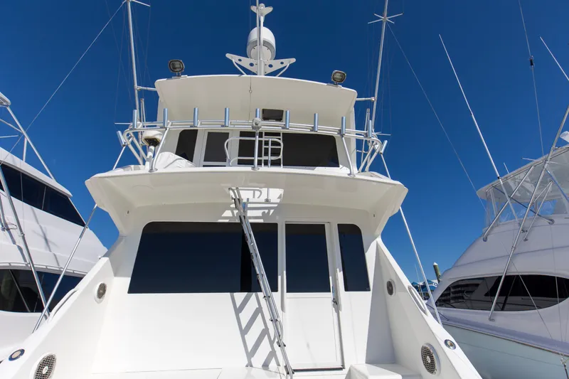 The Image of 1998 Viking 72 Enclosed Bridge yacht with sleek design under clear blue sky. - 0