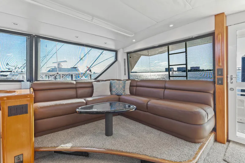 Slide: The Image of Luxurious interior of 1998 Viking 72 Enclosed Bridge yacht with leather seating and ocean view. - 10