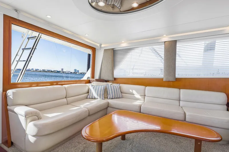 Slide: The Image of Luxurious interior of 1998 Viking 72 Enclosed Bridge yacht with plush seating and ocean view. - 11