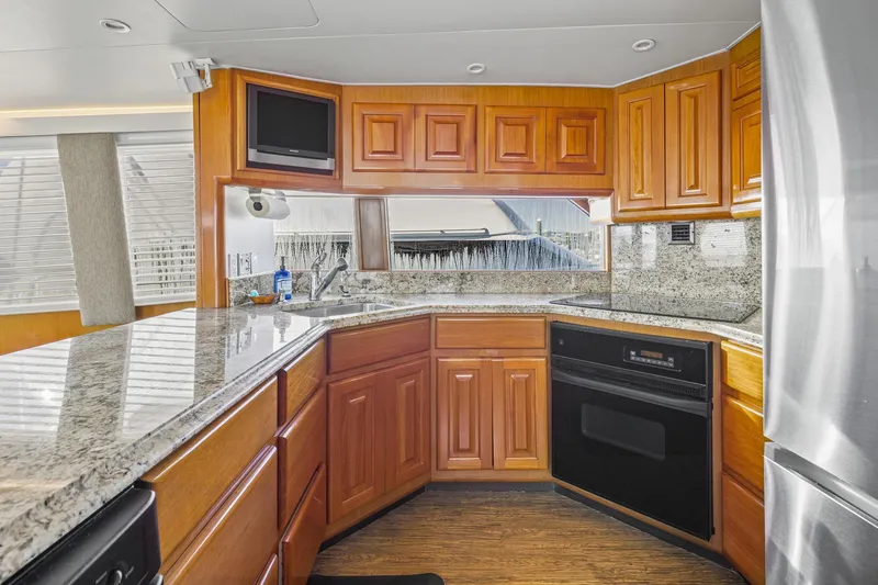 Slide: The Image of Luxurious kitchen interior of 1998 Viking 72 Enclosed Bridge yacht with granite countertops. - 14