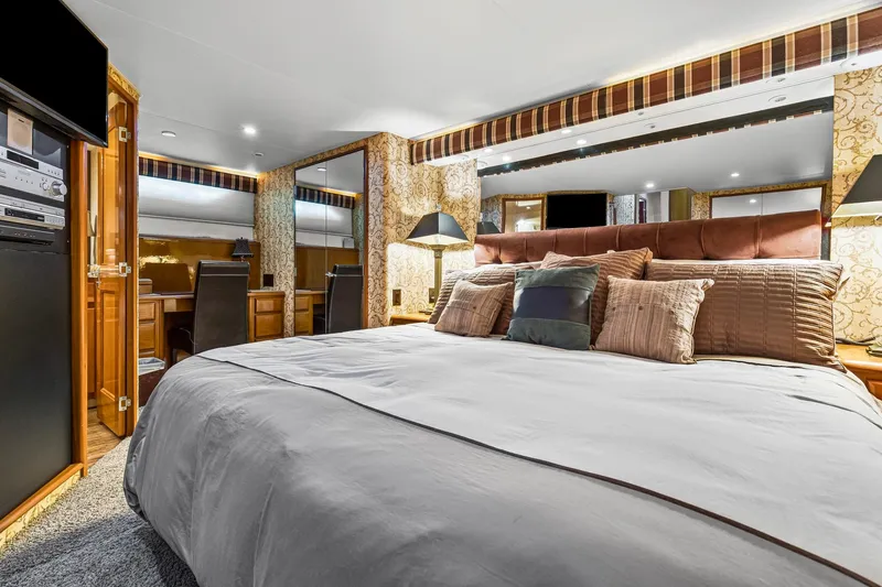 Slide: The Image of Luxurious bedroom interior of 1998 Viking 72 Enclosed Bridge yacht with elegant decor. - 15