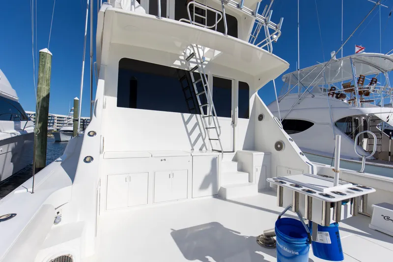 Slide: The Image of 1998 Viking 72 Enclosed Bridge yacht docked, showcasing spacious deck and sleek design. - 2