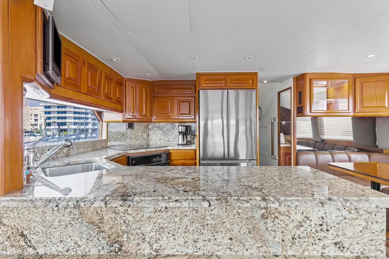 Slide: The Image of Luxurious kitchen interior of 1998 Viking 72 Enclosed Bridge yacht with granite countertops. - 24