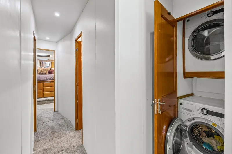 Slide: The Image of Hallway in 1998 Viking 72 Enclosed Bridge yacht with laundry area and bedroom view. - 27