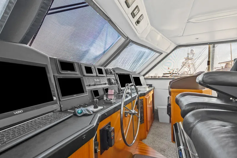 Slide: The Image of Interior of 1998 Viking 72 Enclosed Bridge yacht with modern navigation equipment. - 5