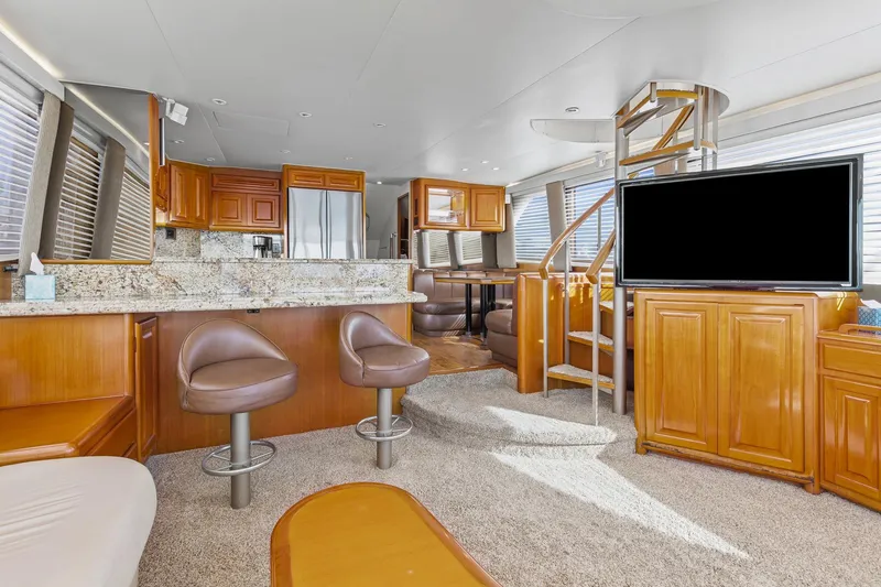 Slide: The Image of Luxurious interior of 1998 Viking 72 Enclosed Bridge yacht with modern kitchen and seating. - 6