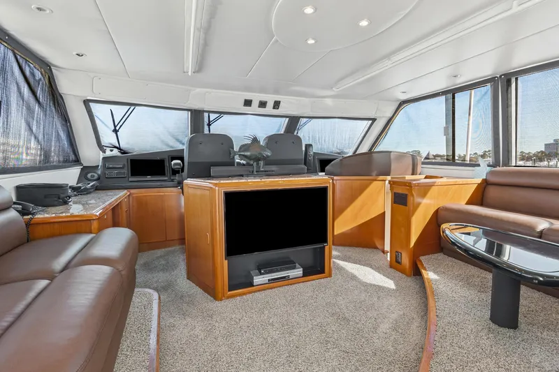 Slide: The Image of Luxurious interior of 1998 Viking 72 Enclosed Bridge yacht with leather seating and modern amenities. - 7
