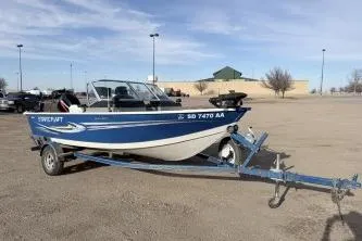 The Image of 2009 Starcraft Starfire 1600 DC boat on trailer in parking lot. - 1
