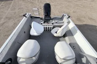 Slide: The Image of 2009 Starcraft Starfire 1600 DC boat interior with white seating and motor. - 5