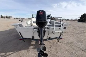 Slide: The Image of 2009 Starcraft Starfire 1600 DC boat with outboard motor, parked on gravel. - 6