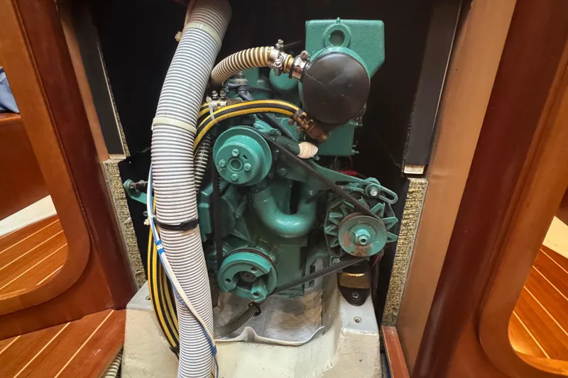 Slide: The Image of Engine compartment of a 2004 Dufour 40 Performance sailboat, showcasing mechanical components. - 16