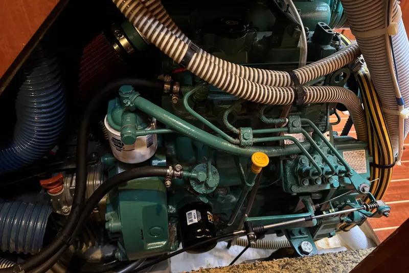 Slide: The Image of Engine compartment of a 2004 Dufour 40 Performance sailboat, showcasing detailed mechanical components. - 18