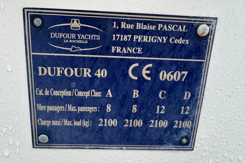 Slide: The Image of Plaque of 2004 Dufour 40 Performance yacht, detailing passenger capacity and load limits. - 22