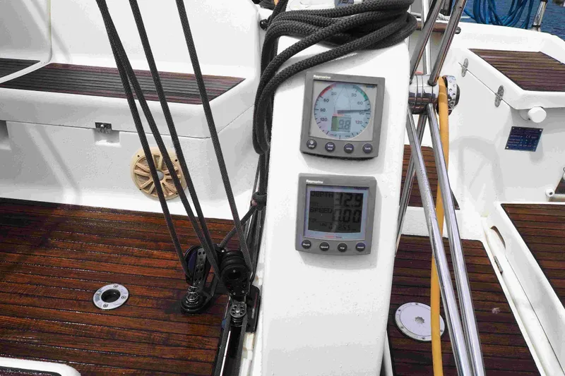 Slide: The Image of Cockpit of 2004 Dufour 40 Performance sailboat with navigation instruments and teak flooring. - 34