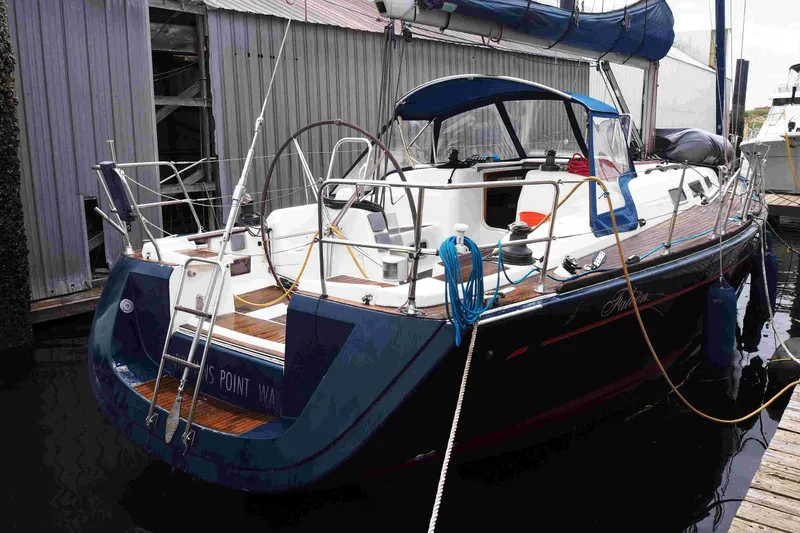 Slide: The Image of 2004 Dufour 40 Performance sailboat docked, featuring sleek design and spacious deck. - 38